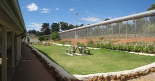 Image of a picnic table inside the perimetre fence at Wooroloo Prison Farm