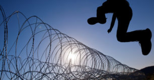 Man leaping razor wire