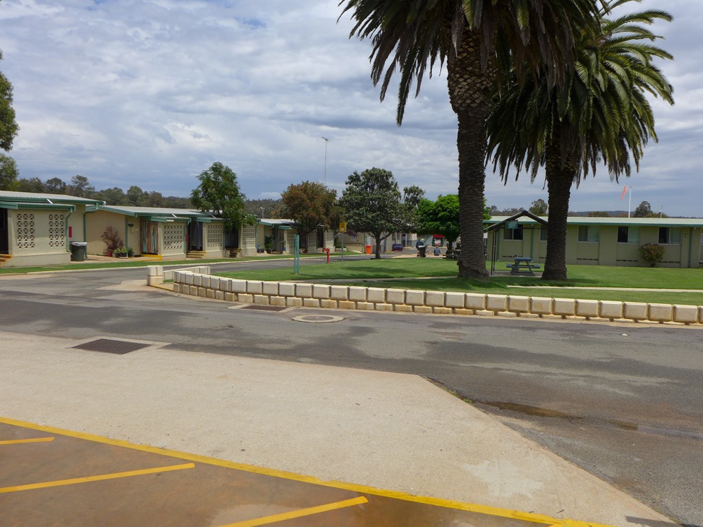 Image of grassed area with seating and accommodation blocks around this area.