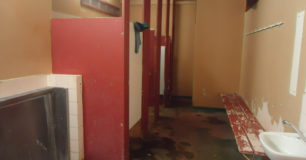 Image of shower cubicles in rundown bathroom facilities at Roebourne Regional Prison