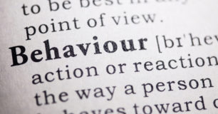 Close up image of the word Behaviour in a dictionary