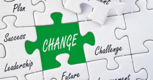 Image of a white jigzaw puzzle with words, and the word change in white with a green background