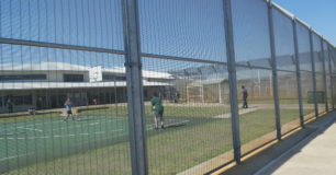 Image of prisoners at Casuarina Prison in a fenced in recreation yard.