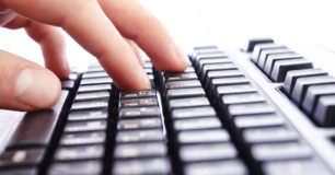 Photo of hands on a keyboard