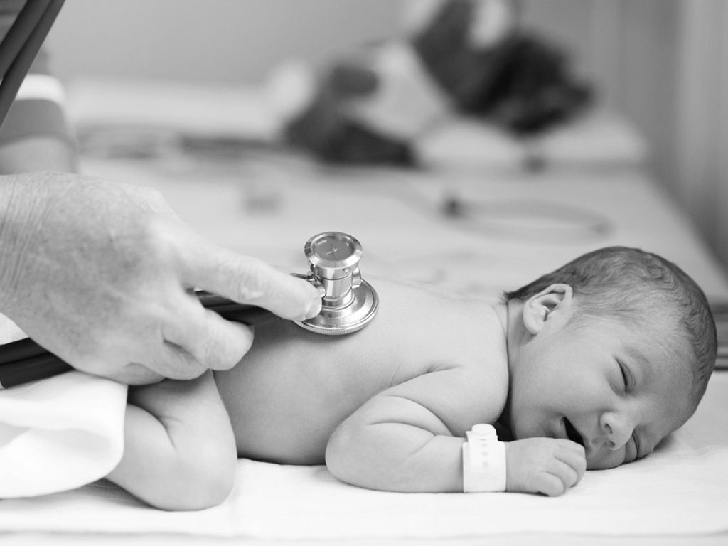 Image of baby being checked with a stethoscope