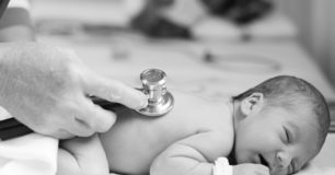 Image of baby being checked with a stethoscope