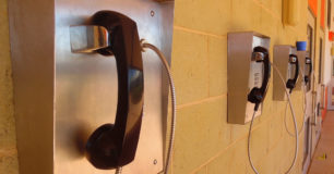 Four prisoner phones on a wall in prison