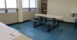 Image of a day room with tables and bench seats, in one of the units at Hakea