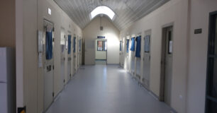 Image of crisis care with cell doors either side of the corridor