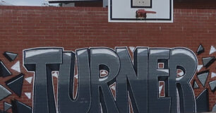 Graffiti art of the name 'Turner' on wall in the basketball court