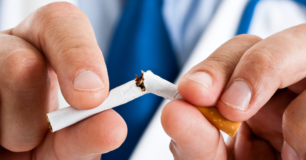 Image of two hands snapping a cigarette in half